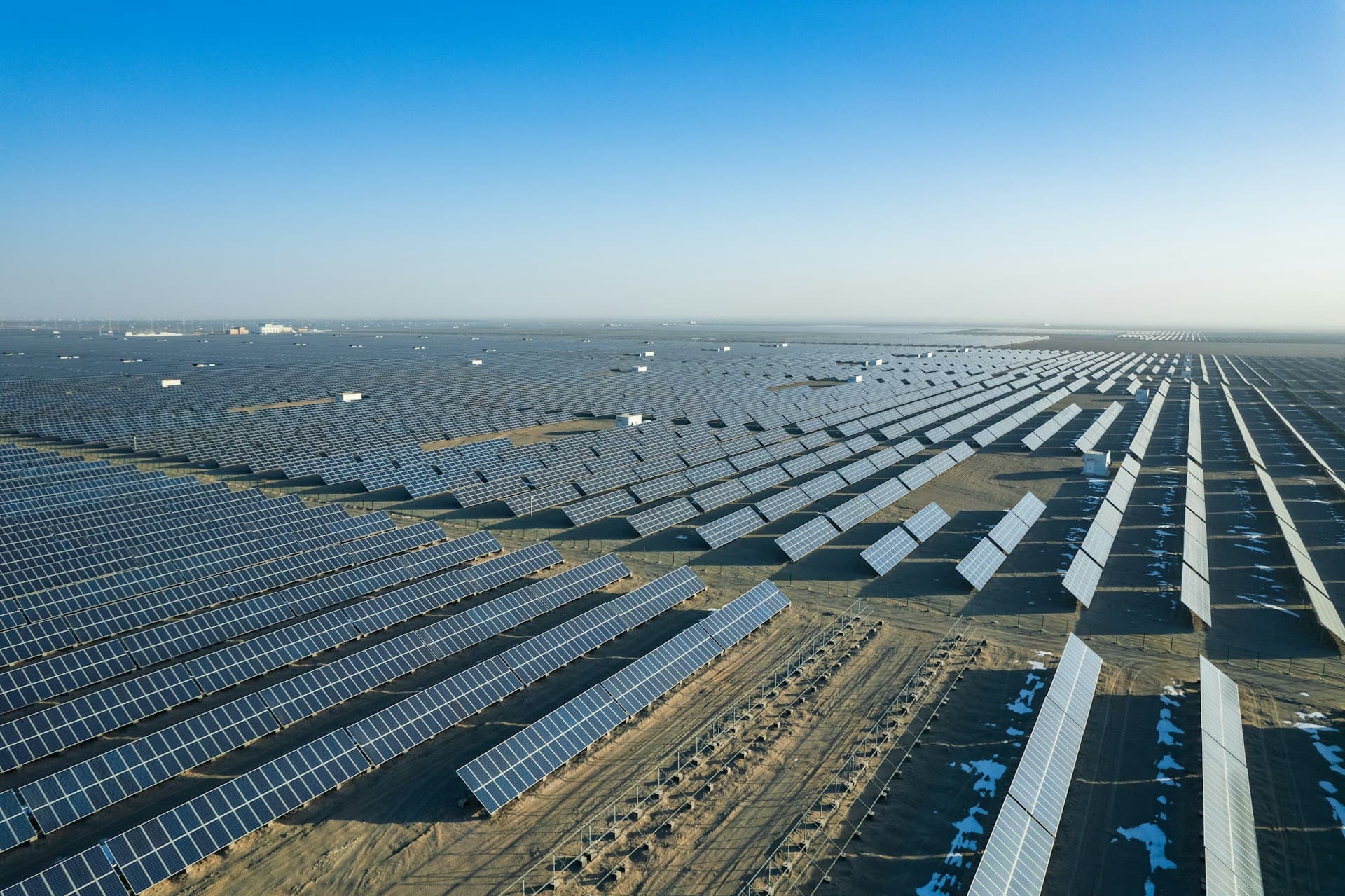 Aerial view of utility-scale solar farm in Arizona desert with mountains