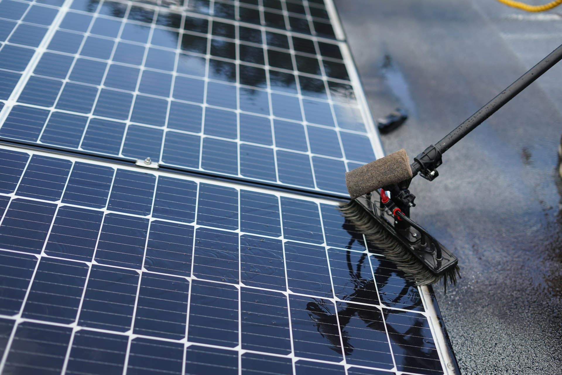 Professional crew cleaning solar panels at a large-scale installation
