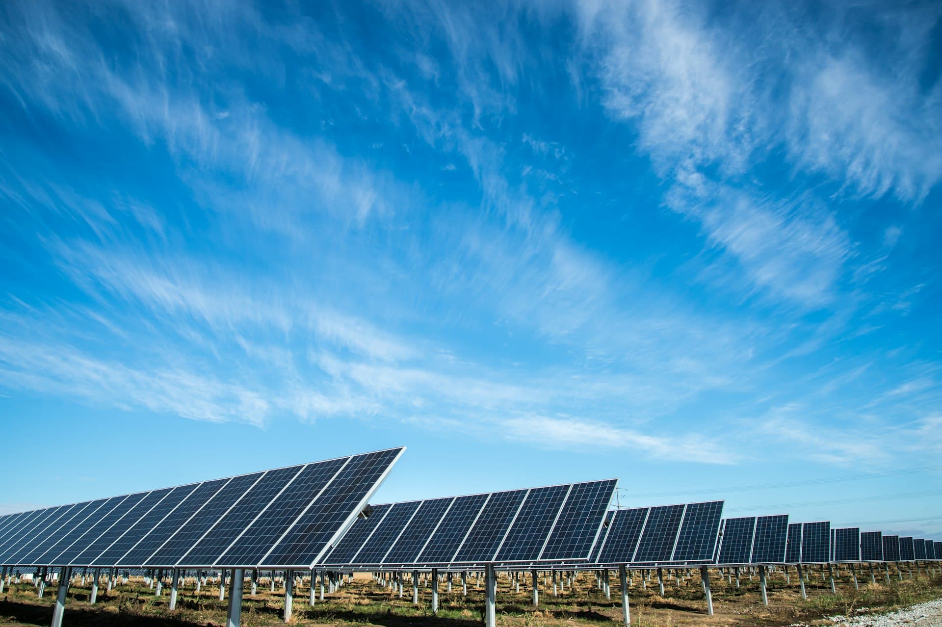 Clean solar panels against a bright blue Arizona sky